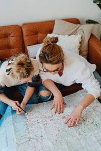 two individuals leaning over a map