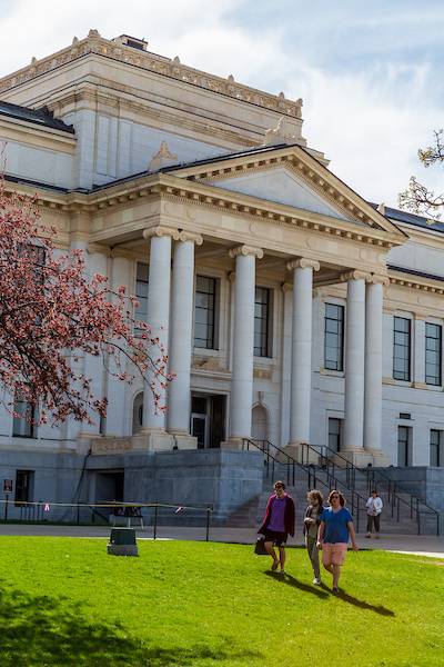 students walking in front of the park building on presidents circle on a spring day
