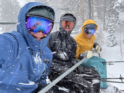 3 students on ski lift in a snowstorm in utah.