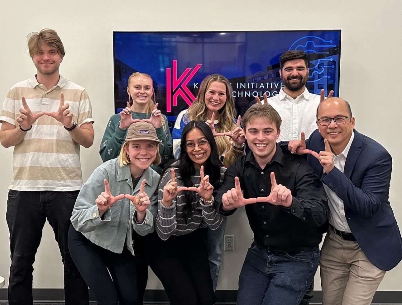 group of college student flashing the u